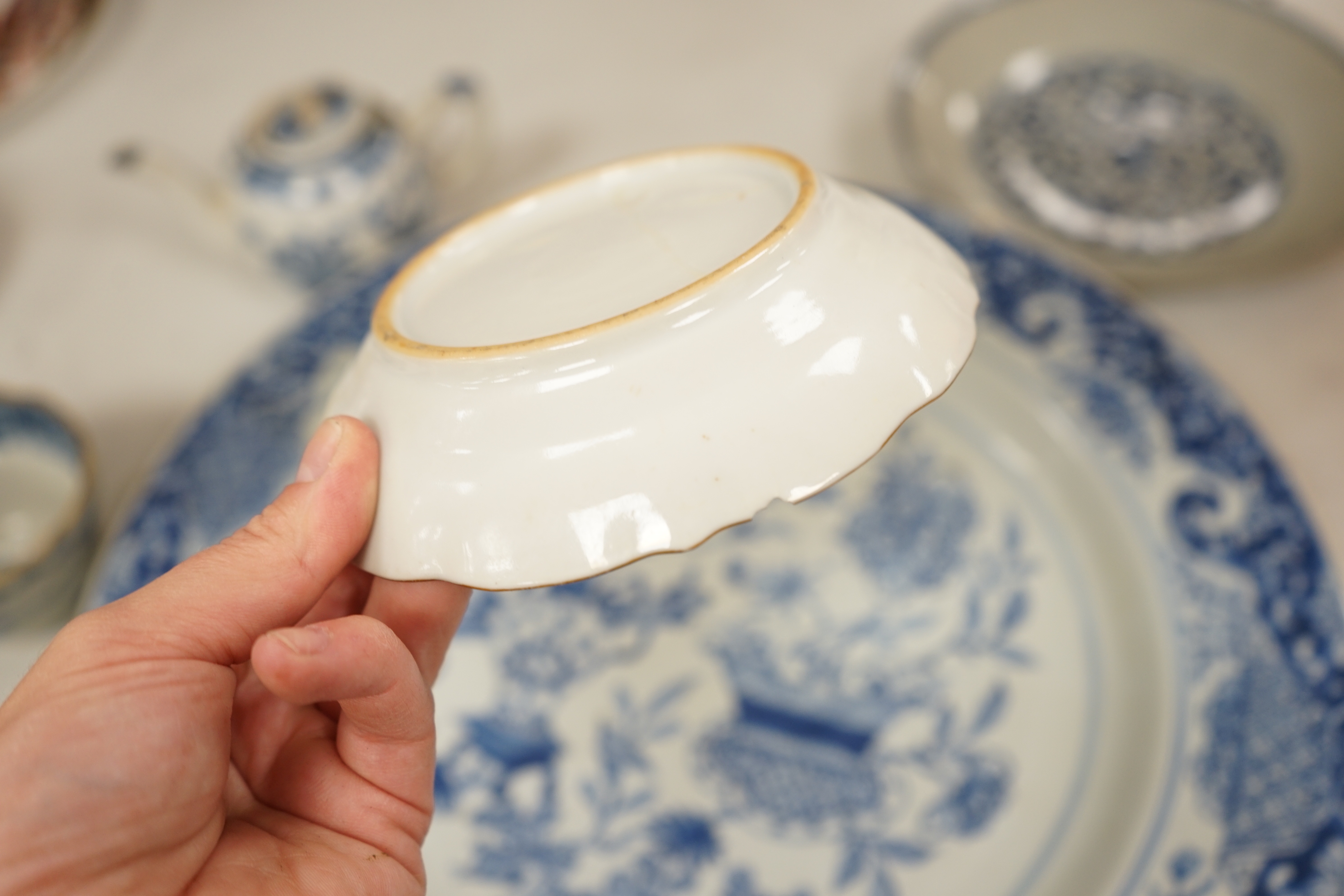 A Worcester teapot, c.1770, two 18th century Chinese porcelain dishes, a cup and saucer, a Chinese shallow bowl and a small teapot, largest dish 39cm